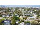 Charming neighborhood aerial view showcases mature trees and beautiful homes with the city skyline in the distance at 531 Luzon Ave, Tampa, FL 33606