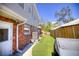 Backyard view with artificial turf, brick accents, and tropical plants at 531 Luzon Ave, Tampa, FL 33606