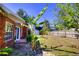 Backyard showcasing a brick house exterior with a shed and banana tree at 531 Luzon Ave, Tampa, FL 33606