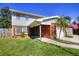 Inviting two-story home with brick accents, featuring a manicured lawn, and an American flag at 531 Luzon Ave, Tampa, FL 33606