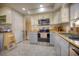 Kitchen with stainless steel appliances, granite counters and light gray cabinets and drawers at 531 Luzon Ave, Tampa, FL 33606