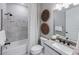 Bathroom with granite counters, patterned shower curtain and decorative woven baskets at 5622 Silverside Pine Ct, Lakewood Ranch, FL 34211