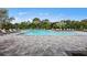 Community pool with plenty of lounge chairs and umbrellas for relaxing by the water at 5622 Silverside Pine Ct, Lakewood Ranch, FL 34211