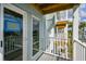 Private balcony with white railings offers serene water views and complements the home's exterior at 649 Garland Cir, Indian Rocks Beach, FL 33785