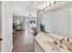 Bright bathroom with hard wood floors leads to a bedroom with sliding glass door to balcony at 649 Garland Cir, Indian Rocks Beach, FL 33785