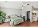 Bright bedroom with leafy bedding, a white rattan dresser, and laminate wood flooring at 649 Garland Cir, Indian Rocks Beach, FL 33785