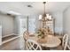 Cozy dining room featuring a classic chandelier, stylish furnishings, and an adjacent bathroom at 649 Garland Cir, Indian Rocks Beach, FL 33785