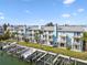 Exterior shot of canal-front townhomes with docks and lifts for boating enthusiasts at 649 Garland Cir, Indian Rocks Beach, FL 33785