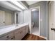 Bathroom featuring vanity with mirror, cabinets, and a doorway to a separate toilet room at 700 Starkey Rd # 1111, Largo, FL 33771