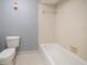 Bathroom featuring a toilet, bathtub with tile surround, and neutral wall color at 700 Starkey Rd # 1111, Largo, FL 33771