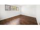 Empty bedroom featuring hardwood floors, white walls, and a window with natural light at 700 Starkey Rd # 1111, Largo, FL 33771