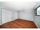 Bedroom with hardwood floors, closet space, and a window offering natural light at 700 Starkey Rd # 1111, Largo, FL 33771