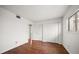 Bedroom features hardwood floors, closet doors, and natural light through a window at 700 Starkey Rd # 1111, Largo, FL 33771