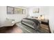 Stylishly staged bedroom showcases a modern bed, armchair, and hardwood floors at 700 Starkey Rd # 1111, Largo, FL 33771