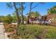Landscaped entrance sign for 700 Forestbrook beneath a clear blue sky at 700 Starkey Rd # 1111, Largo, FL 33771