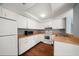 Kitchen features white cabinets, hardwood floors, and stainless steel sink at 700 Starkey Rd # 1111, Largo, FL 33771
