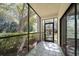 Outdoor patio featuring tiled floors, screened windows, and beautiful green views at 700 Starkey Rd # 1111, Largo, FL 33771