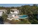 A community pool is surrounded by manicured landscaping, sun loungers and ample patio space at 700 Starkey Rd # 1111, Largo, FL 33771