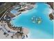 Stunning aerial view of community lagoon with water park, beach and lounge areas and multiple club houses at 7811 Roma Dune Dr, Wesley Chapel, FL 33545