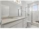 Well-lit bathroom with granite vanity and shower with glass enclosure at 7811 Roma Dune Dr, Wesley Chapel, FL 33545
