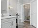 Clean bathroom featuring a white vanity, a mirror, and a separate toilet room at 7811 Roma Dune Dr, Wesley Chapel, FL 33545