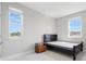 Neutral bedroom features natural light and a simple bed and side table at 7811 Roma Dune Dr, Wesley Chapel, FL 33545
