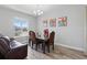 Bright dining room with stylish furniture, natural lighting, and comfortable seating at 7811 Roma Dune Dr, Wesley Chapel, FL 33545