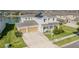Beautiful two-story home boasts a spacious garage, a well-maintained lawn and a sunny front yard at 7811 Roma Dune Dr, Wesley Chapel, FL 33545