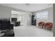 Open concept living space with a comfortable chair, large television, and bright lighting at 7811 Roma Dune Dr, Wesley Chapel, FL 33545