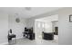 Spacious living room with office space featuring modern decor and an open layout at 7811 Roma Dune Dr, Wesley Chapel, FL 33545