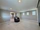 Bright living room featuring recessed lights, neutral walls and a large area rug at 7811 Roma Dune Dr, Wesley Chapel, FL 33545