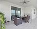 Covered patio featuring an outdoor dining area, a sink, and sliding doors for a seamless indoor-outdoor living at 7811 Roma Dune Dr, Wesley Chapel, FL 33545
