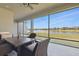 Relaxing screened-in patio with a view of the lake, featuring stylish outdoor furniture and ample seating at 7811 Roma Dune Dr, Wesley Chapel, FL 33545