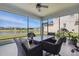 Enjoy the lake view from the screened-in patio, complete with a cozy seating area and scenic surroundings at 7811 Roma Dune Dr, Wesley Chapel, FL 33545