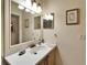 Well-lit bathroom featuring a vanity with a framed mirror and neutral décor at 8141 Ambersweet Pl, Land O Lakes, FL 34637