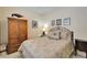 Cozy bedroom with vintage armoire, bedside tables and lamps, and framed wall art, providing a tranquil space at 8141 Ambersweet Pl, Land O Lakes, FL 34637