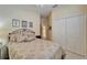 Comfortable bedroom with a patterned bedspread, closet, and calming wall art, offering a relaxing retreat at 8141 Ambersweet Pl, Land O Lakes, FL 34637