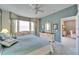 Relaxing bedroom with a blue color scheme, large windows, and a ceiling fan at 8141 Ambersweet Pl, Land O Lakes, FL 34637