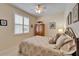 Cozy bedroom featuring plush bedding, ceiling fan, and a window with wooden blinds at 8141 Ambersweet Pl, Land O Lakes, FL 34637