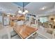 Dining room next to eat-in kitchen with white chairs and wood table at 8141 Ambersweet Pl, Land O Lakes, FL 34637