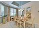 Charming dining room boasts a wooden table set beneath a tray ceiling and large mirrors at 8141 Ambersweet Pl, Land O Lakes, FL 34637