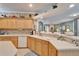 Spacious kitchen features light wood cabinets and a view to the living room at 8141 Ambersweet Pl, Land O Lakes, FL 34637