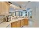 Bright kitchen with light wood cabinets, sink and view of the dining and living room at 8141 Ambersweet Pl, Land O Lakes, FL 34637