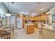 Eat-in kitchen features light wood cabinets, white appliances, and a center island at 8141 Ambersweet Pl, Land O Lakes, FL 34637