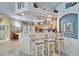 Open-concept kitchen featuring light wood cabinets and a breakfast bar at 8141 Ambersweet Pl, Land O Lakes, FL 34637