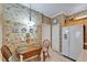 Quaint kitchen nook with a vintage table set, custom wallpaper, and bright light fixture at 8141 Ambersweet Pl, Land O Lakes, FL 34637