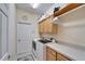 Well-organized laundry room with washer, dryer, and ample storage cabinets at 8141 Ambersweet Pl, Land O Lakes, FL 34637