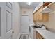 Well-organized laundry room with washer, dryer, and ample storage cabinets at 8141 Ambersweet Pl, Land O Lakes, FL 34637