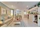 Bright and open living room featuring tile floors, comfortable seating, and views into the dining area at 8141 Ambersweet Pl, Land O Lakes, FL 34637