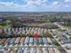 Aerial shot of a quiet neighborhood featuring well-maintained homes and green spaces, marked with a location pin at 8141 Ambersweet Pl, Land O Lakes, FL 34637